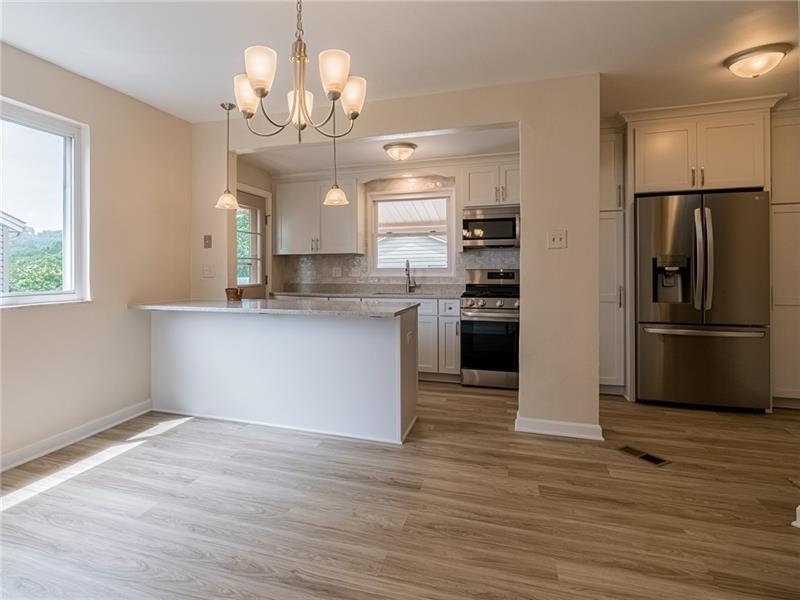 925 Greenhill Road Pittsburgh, PA 15209 - Photo 5 of 27 a kitchen with kitchen island granite countertop a refrigerator oven a sink and dishwasher
