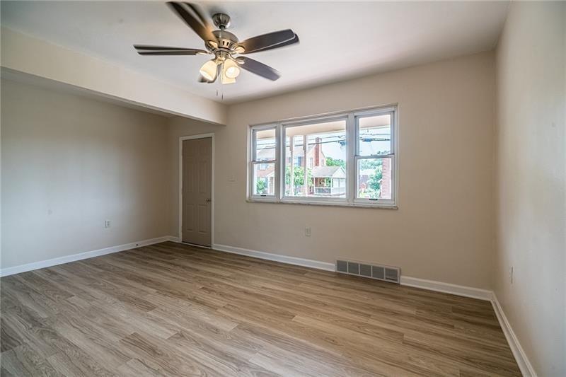 925 Greenhill Road Pittsburgh, PA 15209 - Photo 9 of 27 an empty room with wooden floor and windows