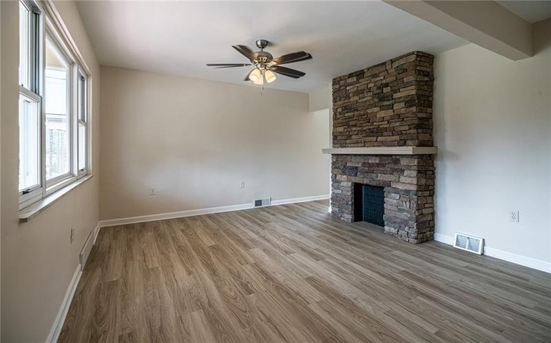 925 Greenhill Road Pittsburgh, PA 15209 - Photo 10 of 27 wooden floor in an empty room with a fireplace
