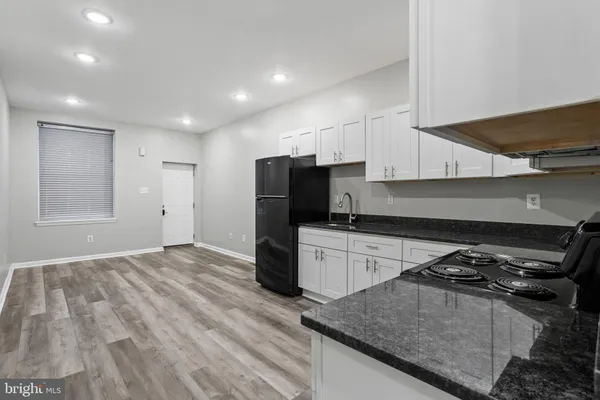 a kitchen with a stove and a refrigerator