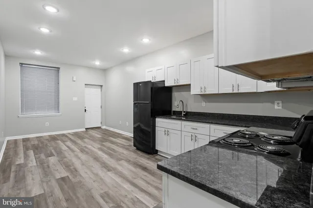 a kitchen with a stove and a refrigerator