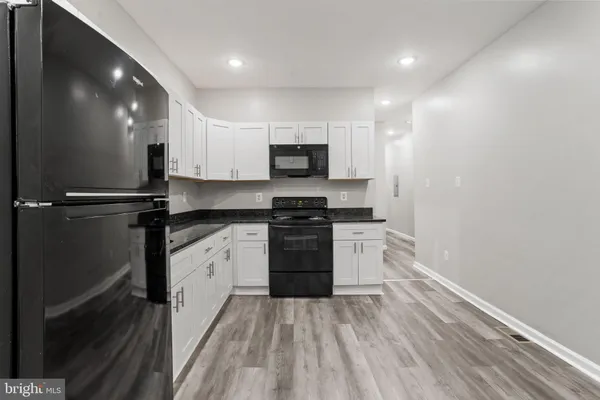 a kitchen with a sink and a stove top oven