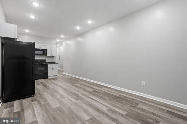 a view of kitchen with refrigerator and window
