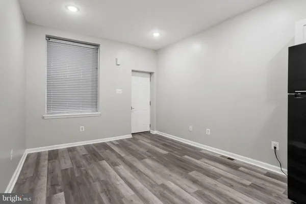 a view of room with window and wooden floor
