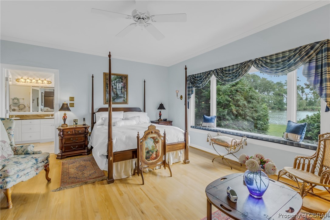 181 Duckbill Road White Stone, VA 22578 - Photo 26 of 50 Hardwood floored bedroom with crown molding, multiple windows, and ceiling fan