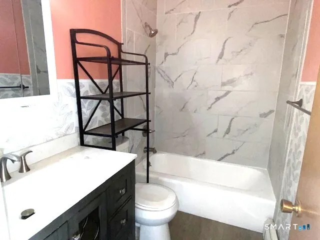 a bathroom with a sink toilet vanity and tub