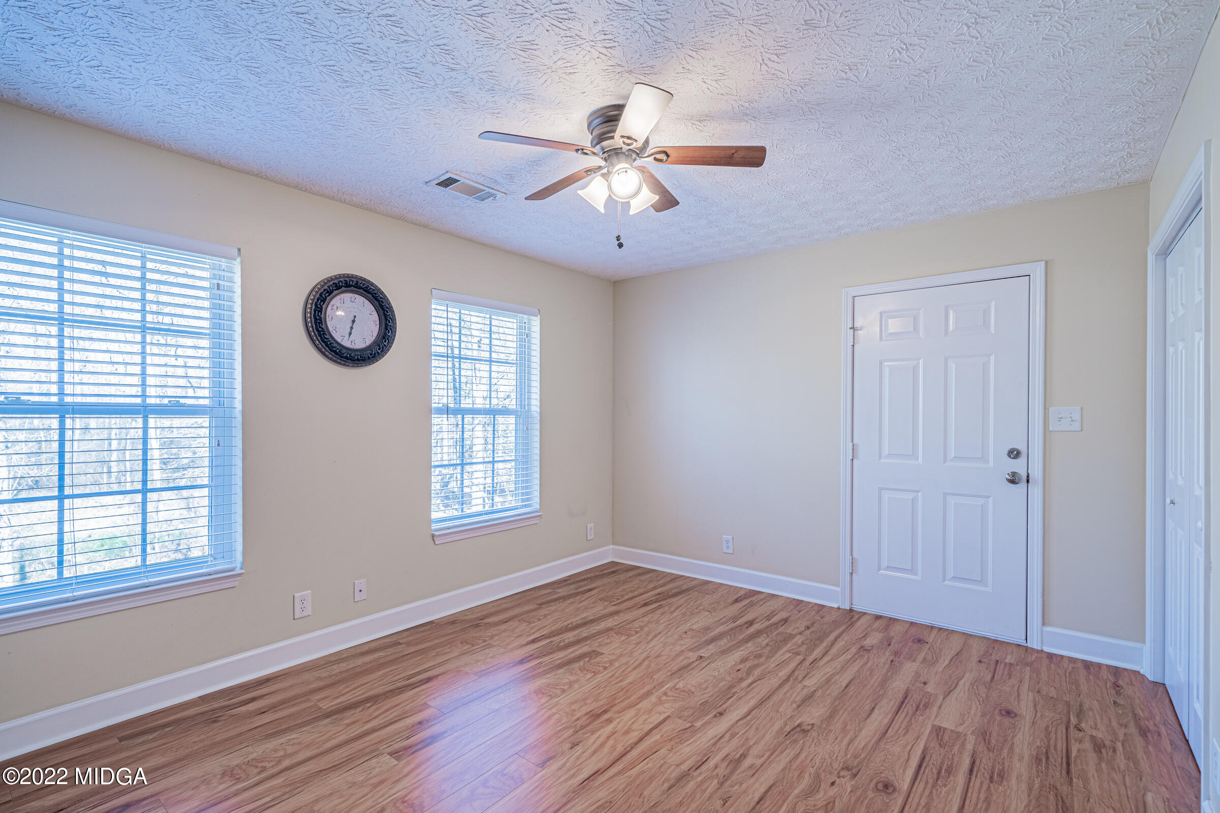 229 Howard Roberts Road Gray, GA 31032 - Photo 14 of 28 a view of an empty room with wooden floor and a window