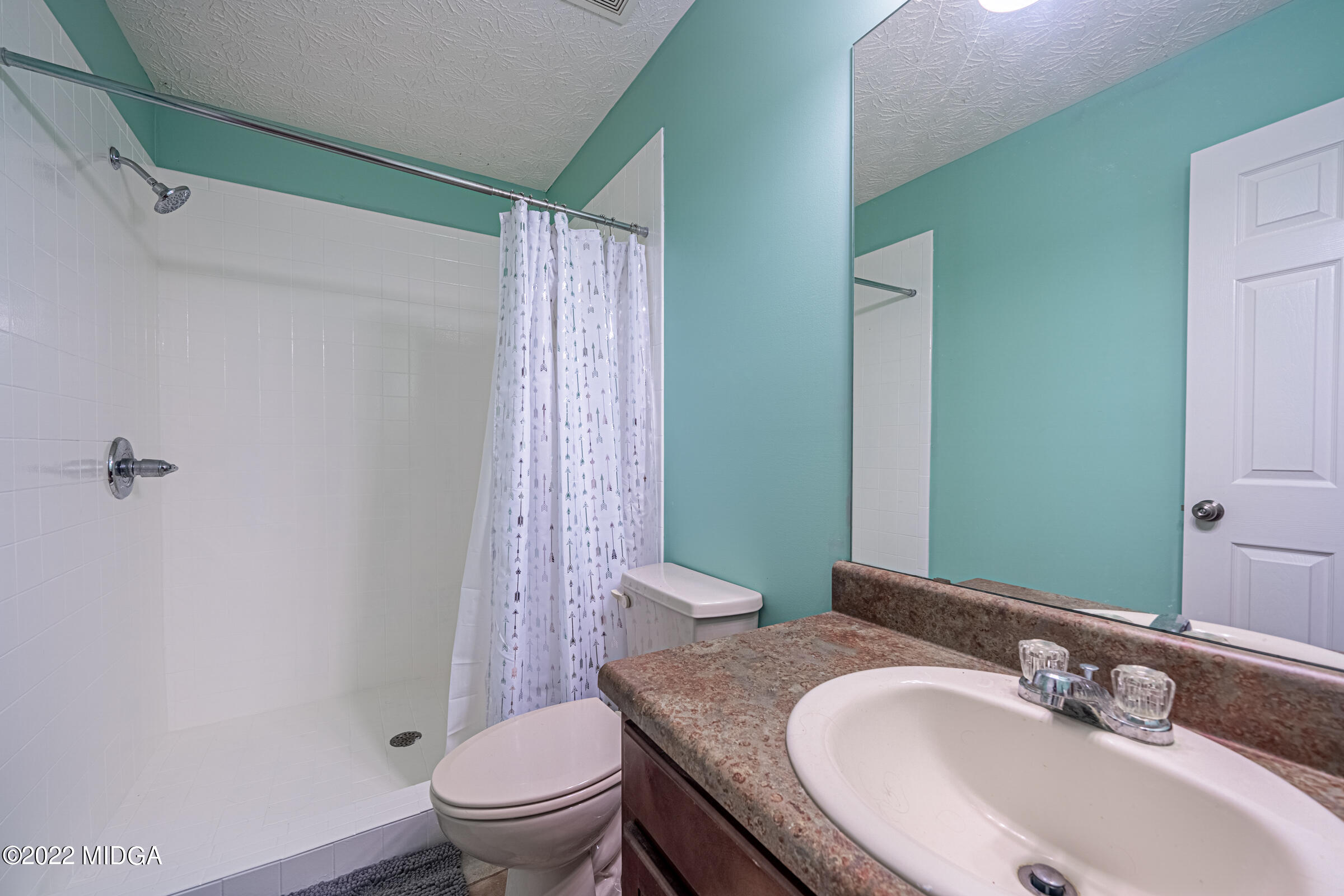 229 Howard Roberts Road Gray, GA 31032 - Photo 17 of 28 a bathroom with a granite countertop sink a toilet and a mirror