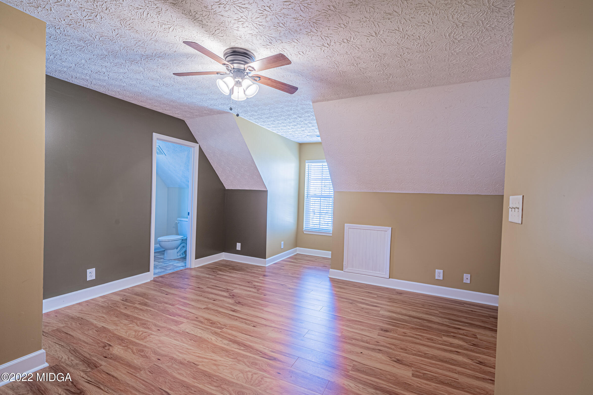 229 Howard Roberts Road Gray, GA 31032 - Photo 19 of 28 a view of an empty room with wooden floor