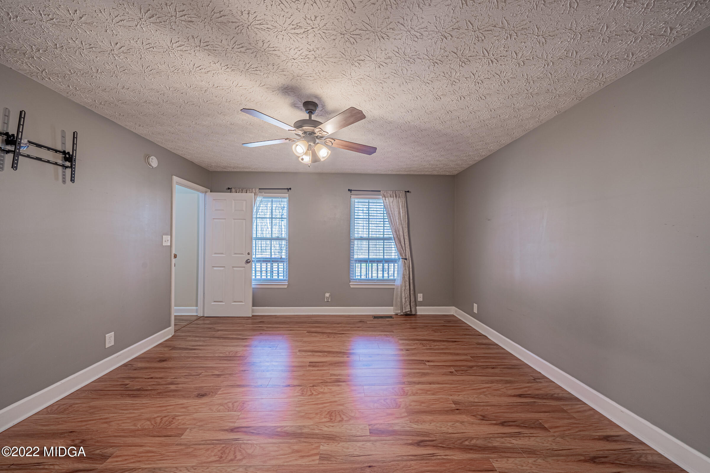 229 Howard Roberts Road Gray, GA 31032 - Photo 9 of 28 wooden floor in an empty room with a window