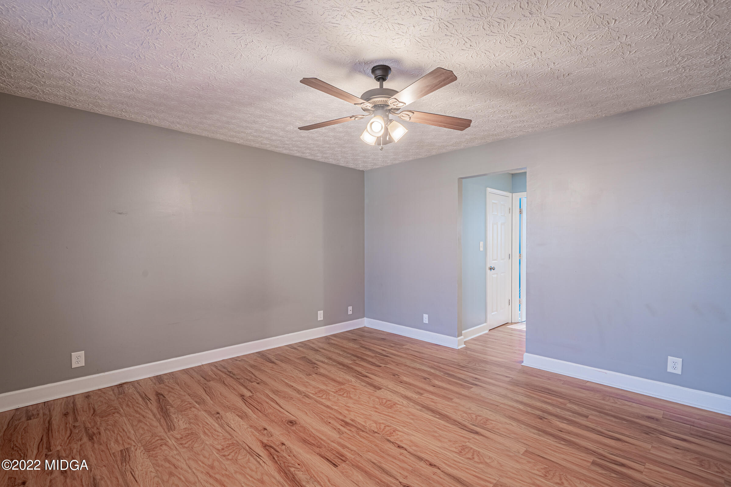 229 Howard Roberts Road Gray, GA 31032 - Photo 10 of 28 a view of an empty room with wooden floor