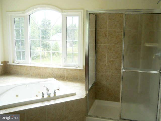 2375 Mountain Road Haymarket, VA 20169 - Photo 12 of 19 a bathroom with a bathtub and a shower