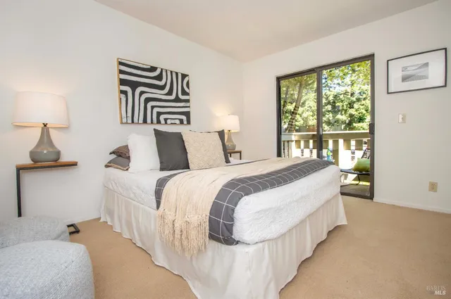 a bedroom with a large bed and a window