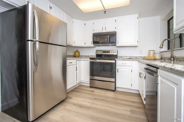 a kitchen with stainless steel appliances a refrigerator stove microwave and sink