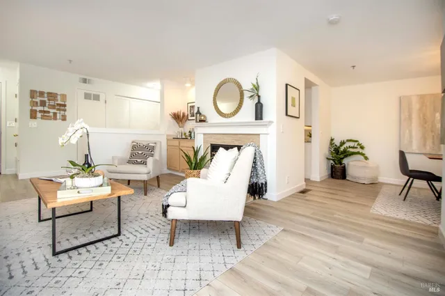 a living room with furniture a rug and a window