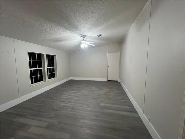 a view of a kitchen with a sink and a refrigerator