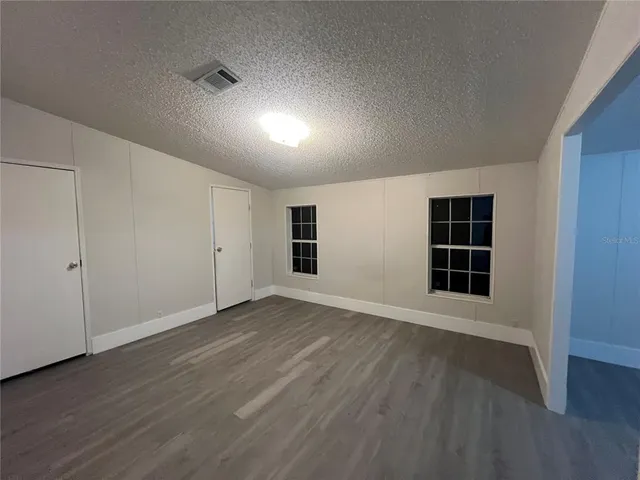a view of a room with wooden floor and window