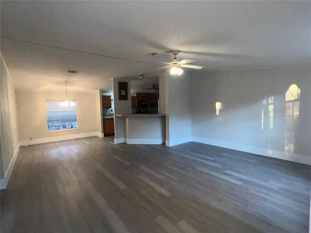 a view of a kitchen with a sink and a refrigerator