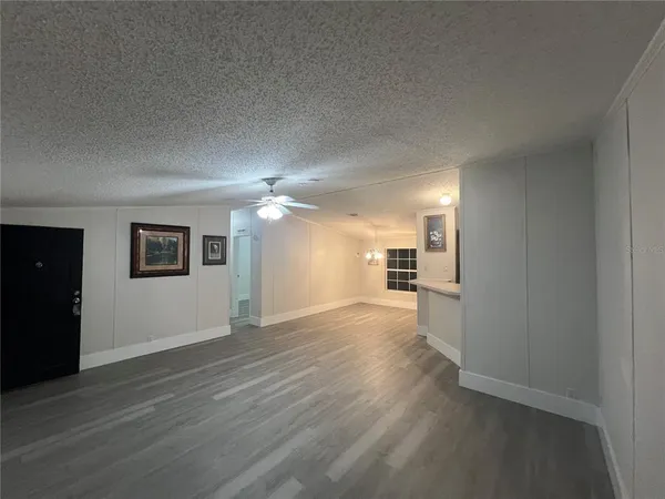a view of a kitchen with wooden floor and windows