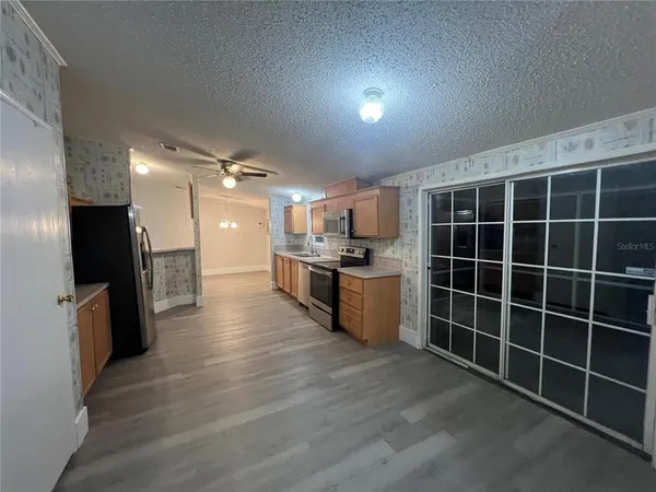 a view of a kitchen with wooden floor and a sink