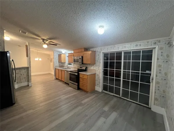 a kitchen with stainless steel appliances granite countertop a sink and a refrigerator