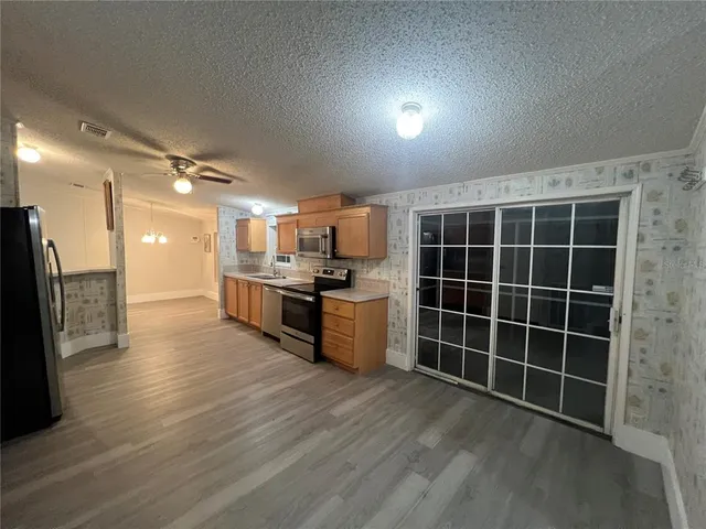 a kitchen with stainless steel appliances granite countertop a sink and a refrigerator