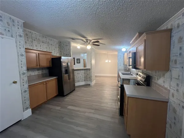 a kitchen with stainless steel appliances a refrigerator and a stove