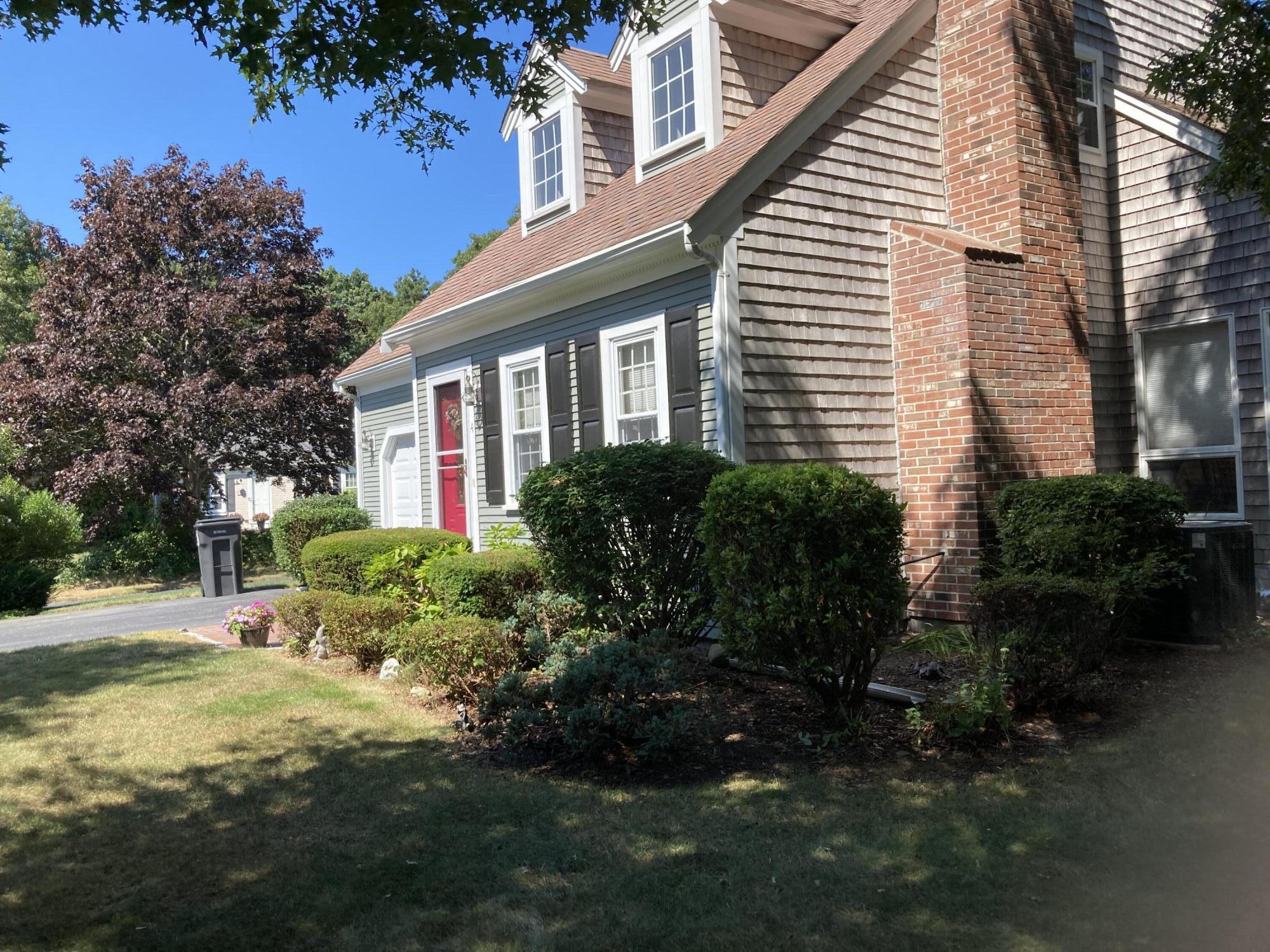 a front view of house with a garden