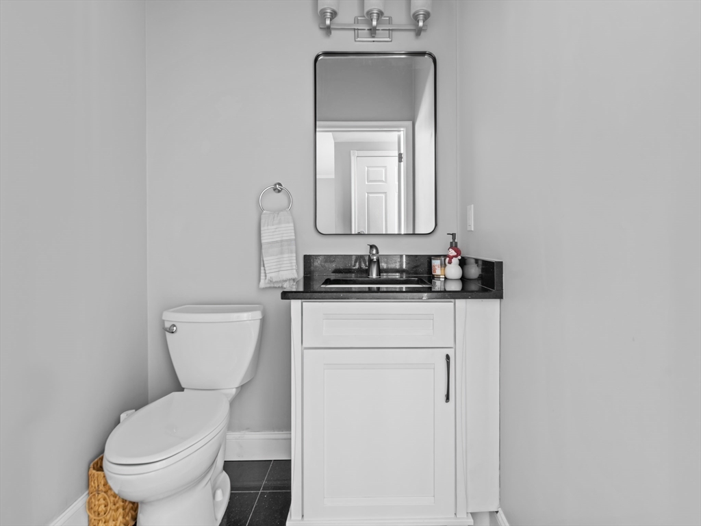 244 Robert Road Marlborough, MA 01752 - Photo 35 of 41 a white toilet sitting next to a bathroom sink