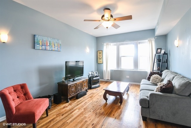 2709 West Lawrence Avenue, Unit 3 Chicago, IL 60625 - Photo 2 of 10 a living room with furniture and a flat screen tv