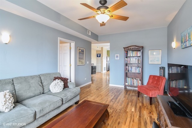 2709 West Lawrence Avenue, Unit 3 Chicago, IL 60625 - Photo 3 of 10 a living room with furniture and a wooden floor