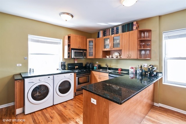 2709 West Lawrence Avenue, Unit 3 Chicago, IL 60625 - Photo 4 of 10 a kitchen with a stove a sink and a refrigerator