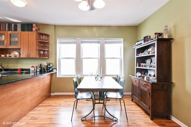 2709 West Lawrence Avenue, Unit 3 Chicago, IL 60625 - Photo 6 of 10 a dining hall with stainless steel appliances granite countertop a table and chairs in it