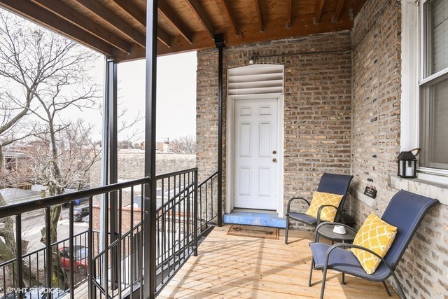 2709 West Lawrence Avenue, Unit 3 Chicago, IL 60625 - Photo 10 of 10 a view of a porch with furniture and a yard