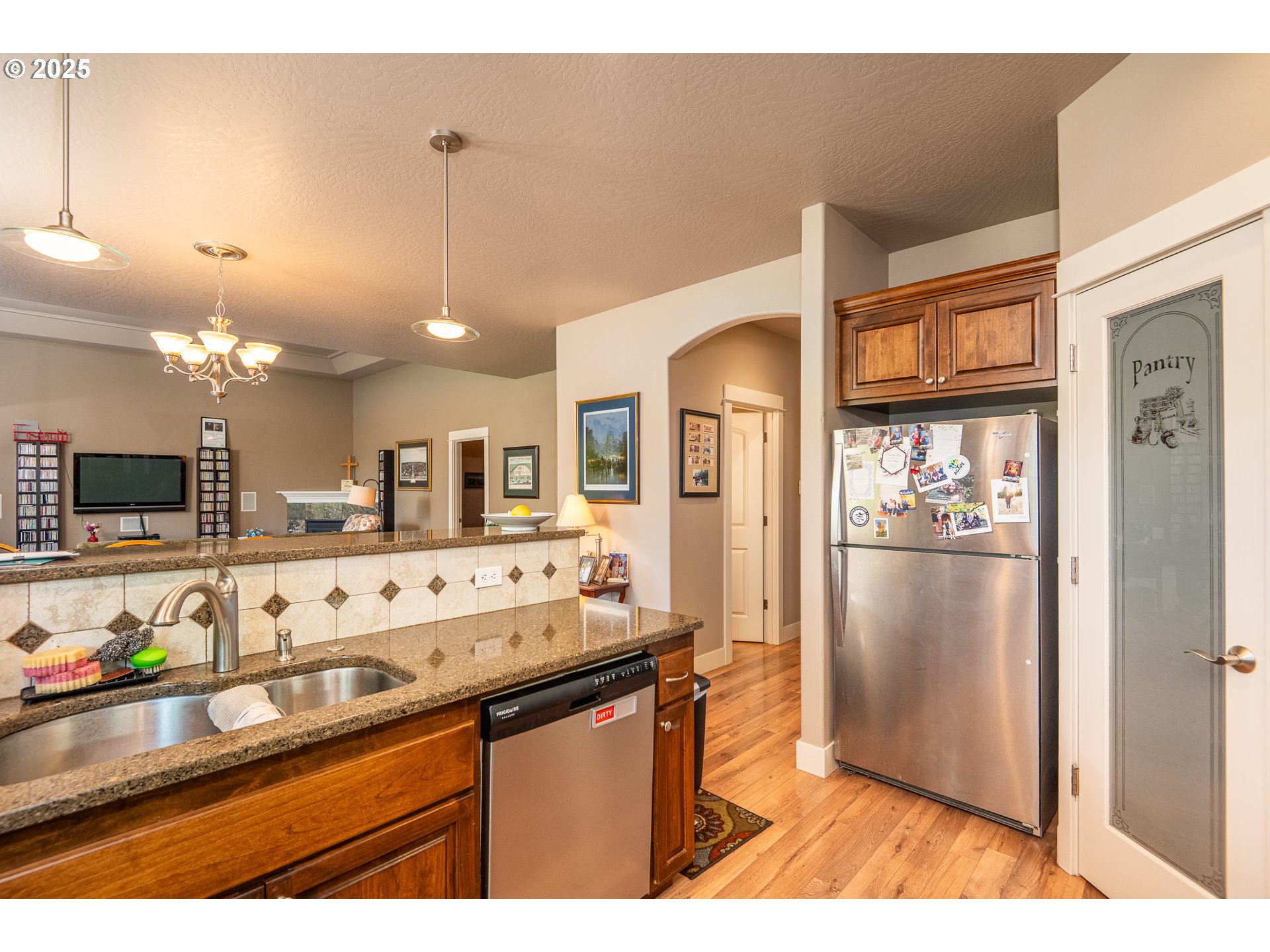 4756 Jessen Drive Eugene, OR 97402 - Photo 14 of 29 a kitchen with stainless steel appliances granite countertop a refrigerator and a sink