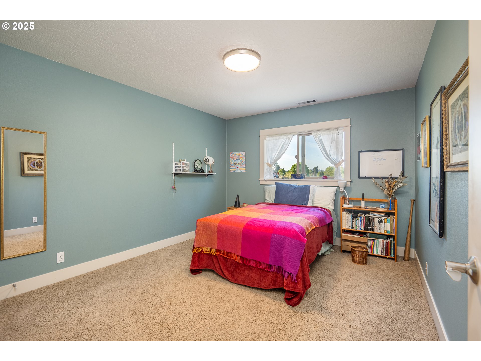 4756 Jessen Drive Eugene, OR 97402 - Photo 19 of 29 a spacious bedroom with a bed and a window