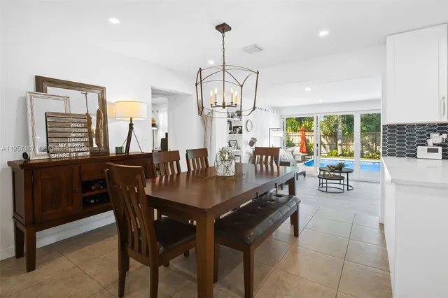 a dining room with furniture a chandelier and a rug