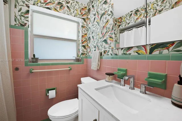 a bathroom with a sink a toilet and a mirror