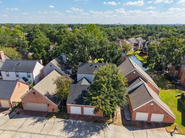 an aerial view of a house with a yard and lake view