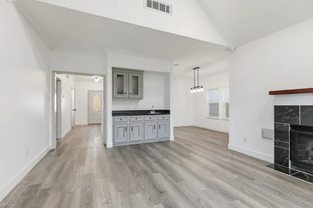 a view of kitchen with sink microwave and refrigerator