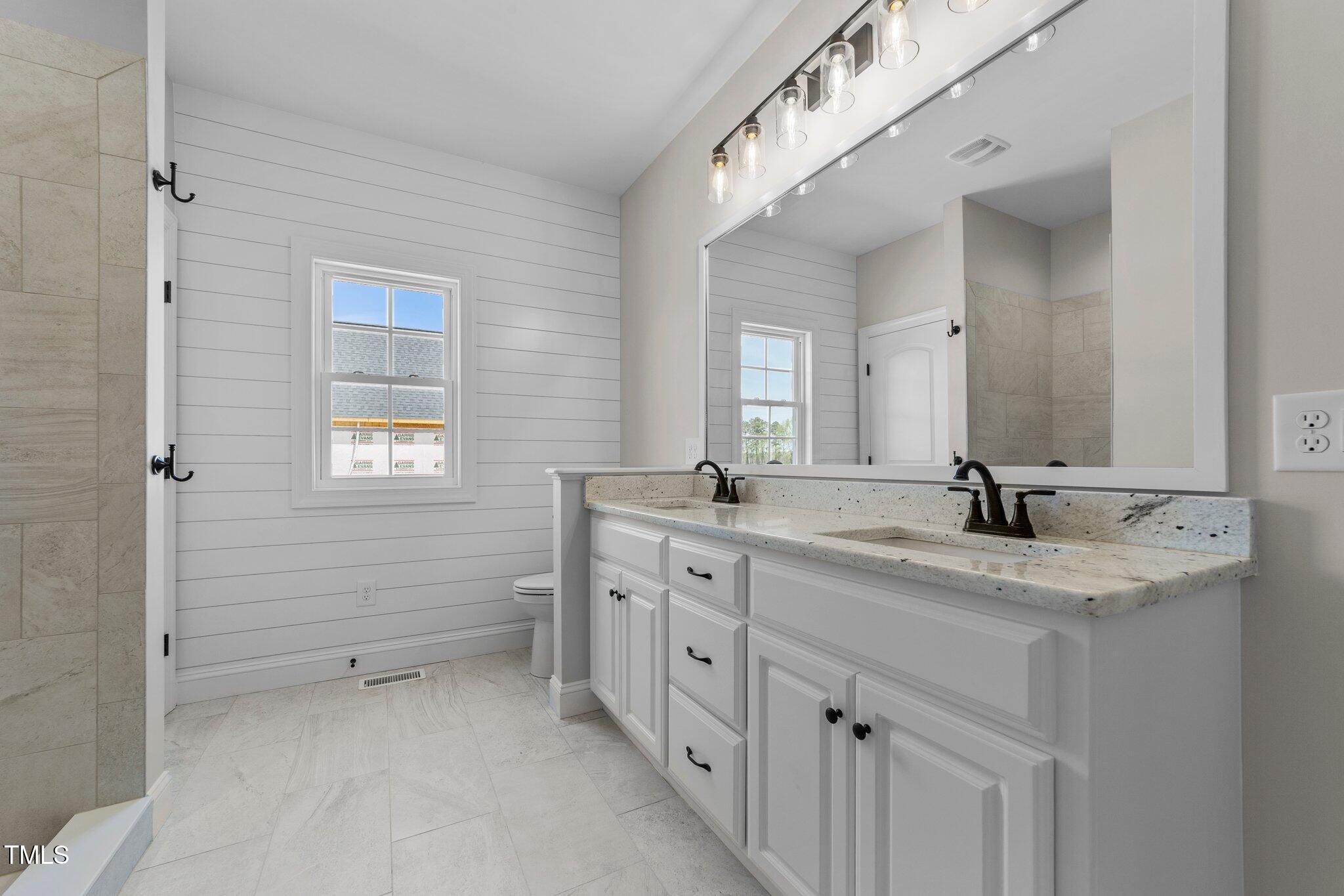 2379 Heartland Road Battleboro, NC 27809 - Photo 15 of 44 a bathroom with a granite countertop sink mirror and a
