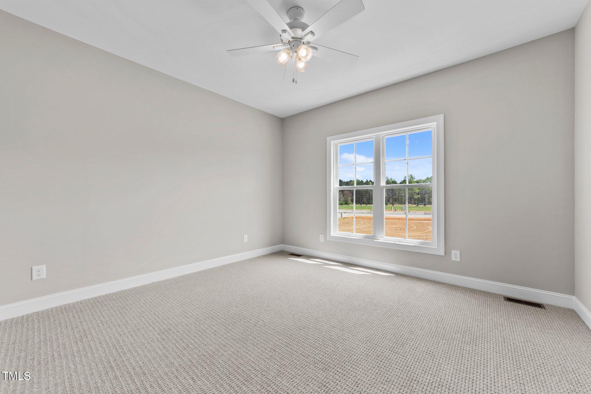 2379 Heartland Road Battleboro, NC 27809 - Photo 18 of 44 an empty room with a window and a fan