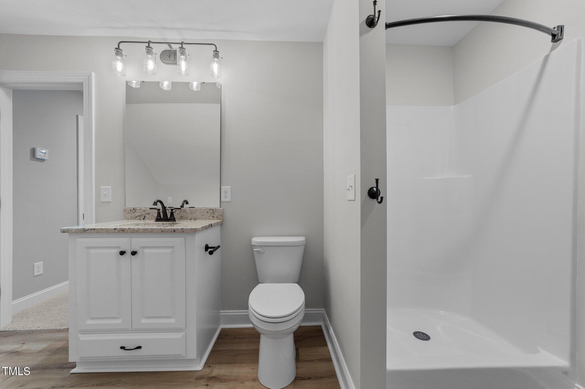 2379 Heartland Road Battleboro, NC 27809 - Photo 26 of 44 a bathroom with a granite countertop sink toilet and shower