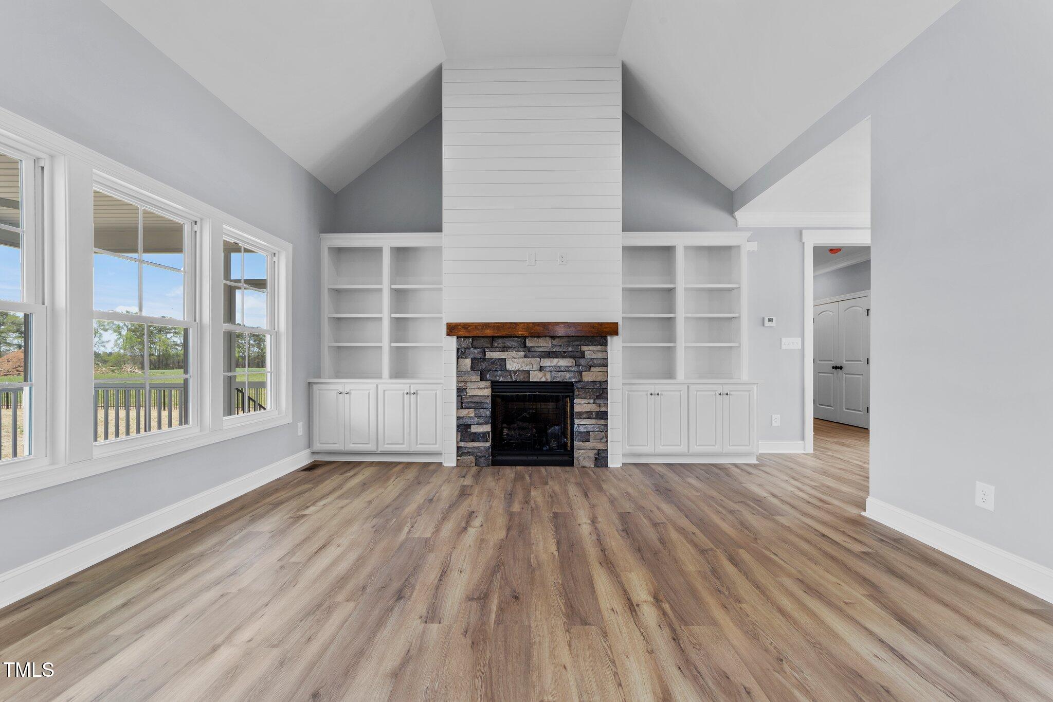 2379 Heartland Road Battleboro, NC 27809 - Photo 9 of 44 wooden floor fireplace and windows in an empty room