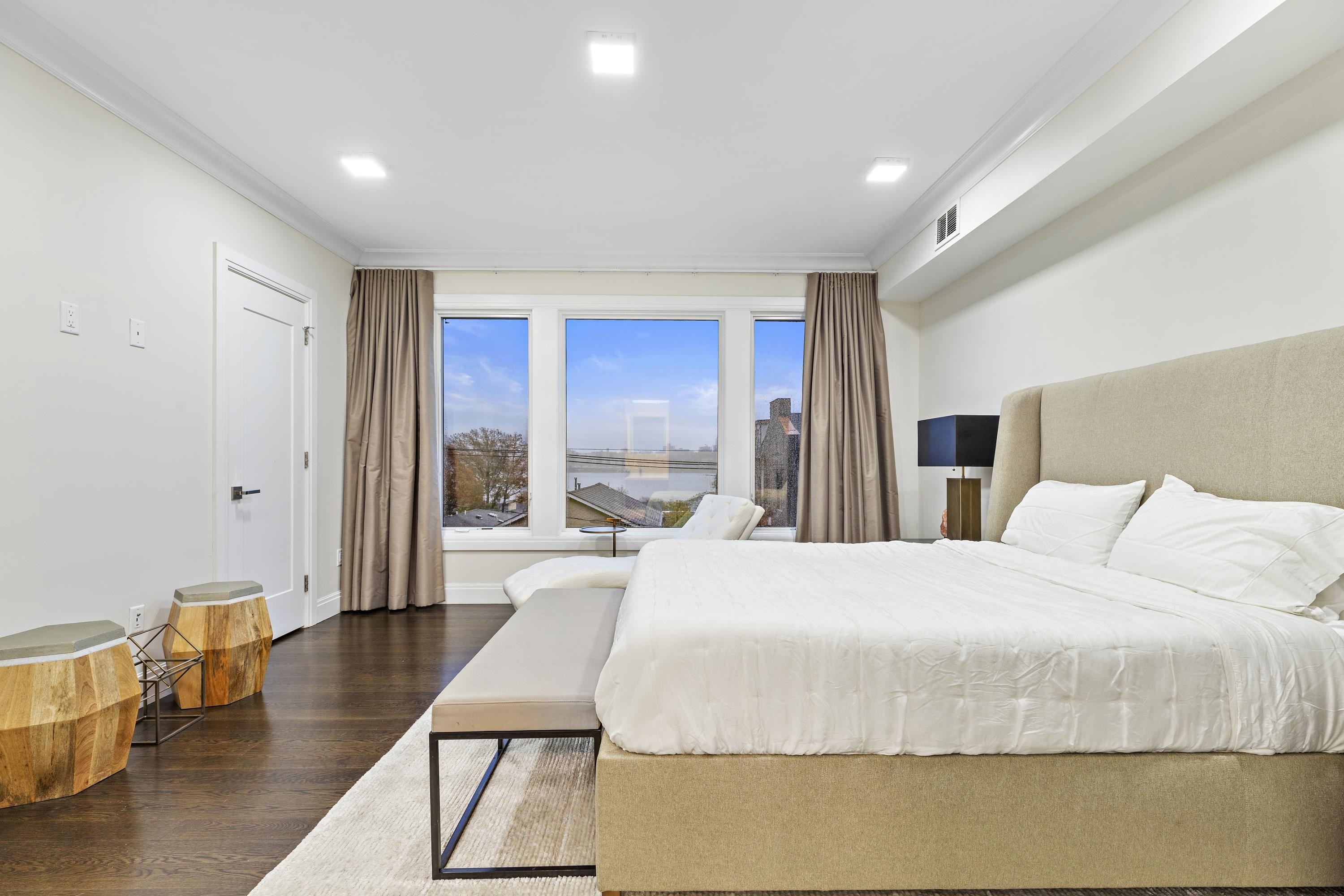640 Undercliff Avenue Edgewater, NJ 07020 - Photo 11 of 26 a spacious bedroom with a bed a table and chair