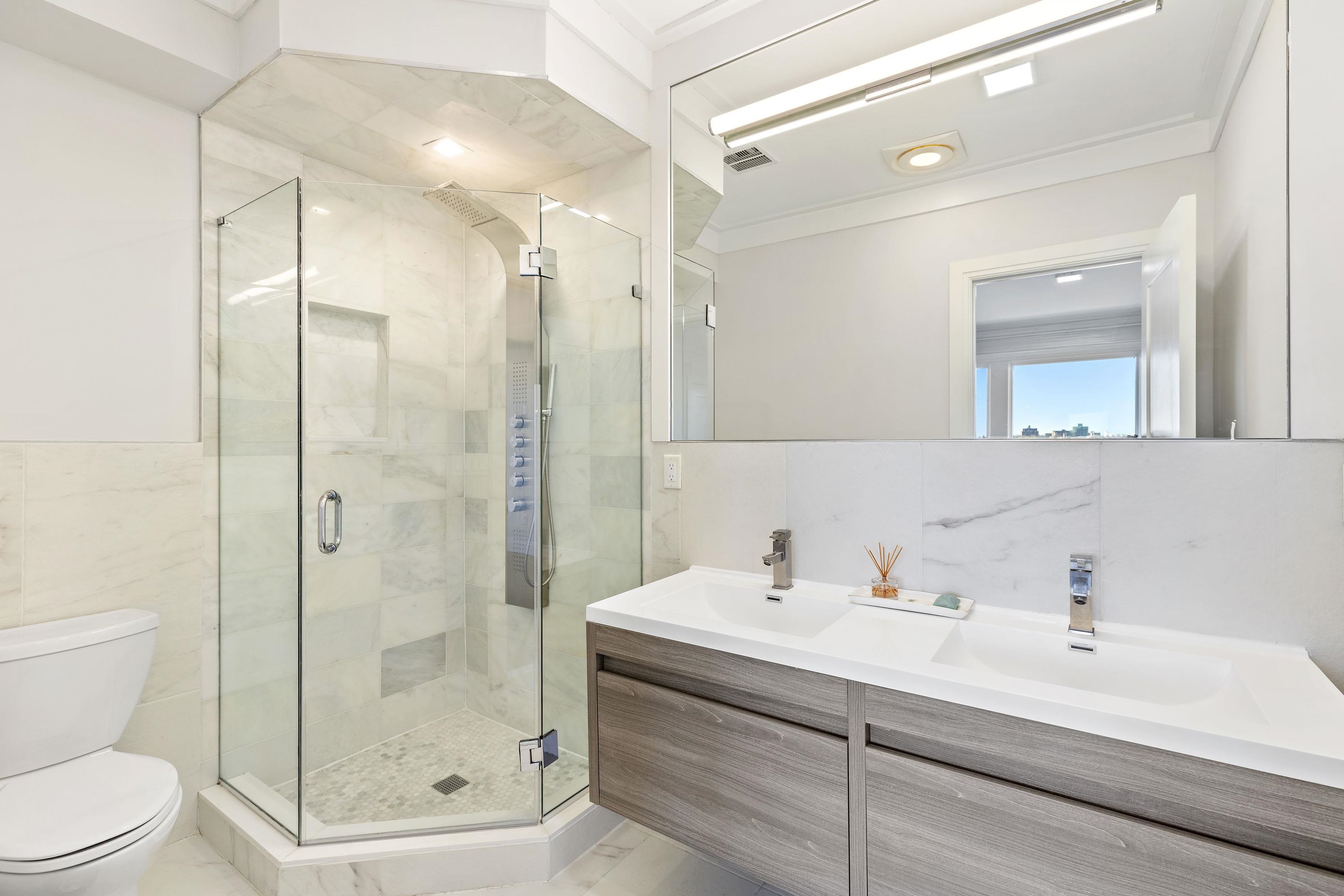 640 Undercliff Avenue Edgewater, NJ 07020 - Photo 12 of 26 a bathroom with a sink a toilet and shower