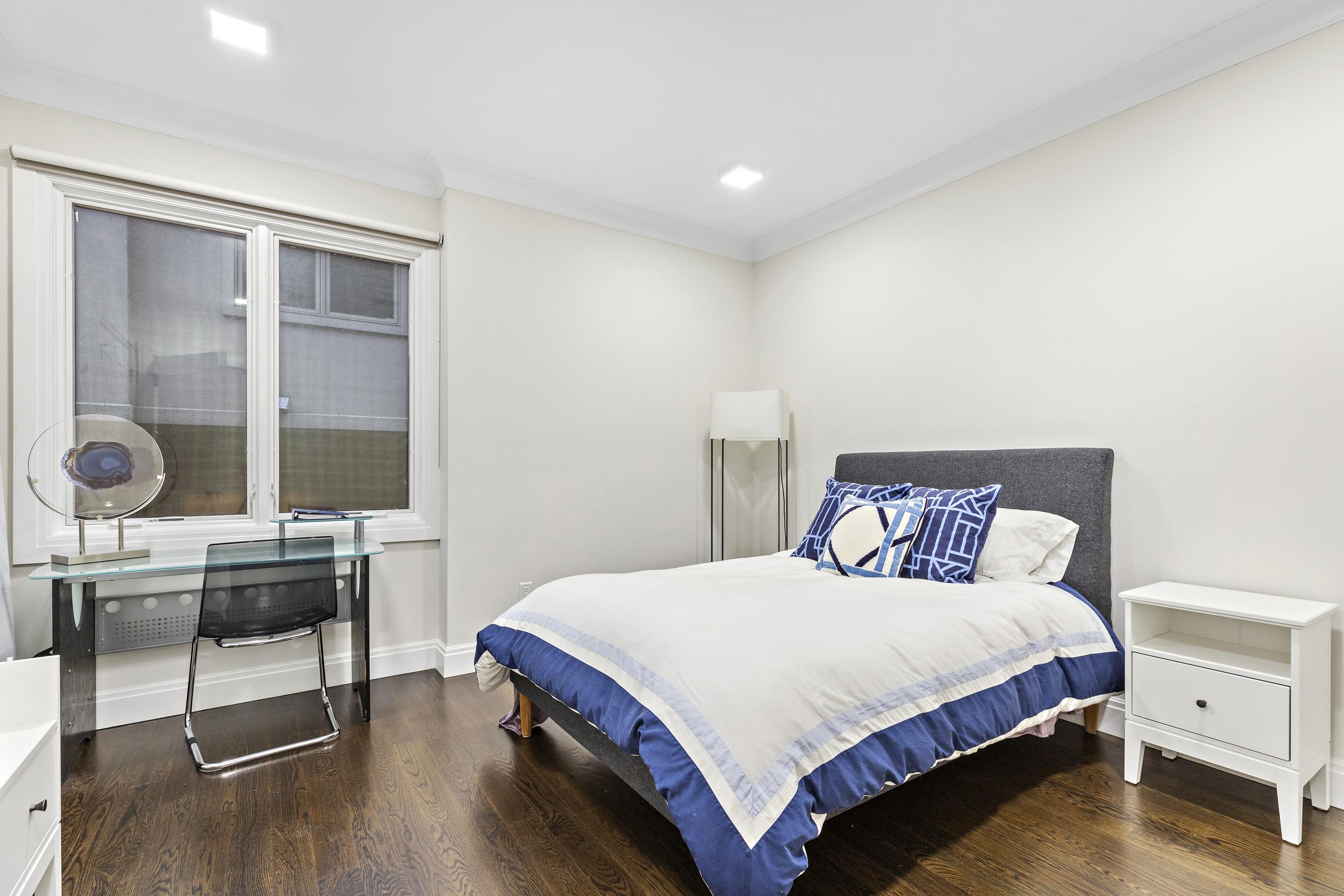 640 Undercliff Avenue Edgewater, NJ 07020 - Photo 13 of 26 a bedroom with a bed and a table in it