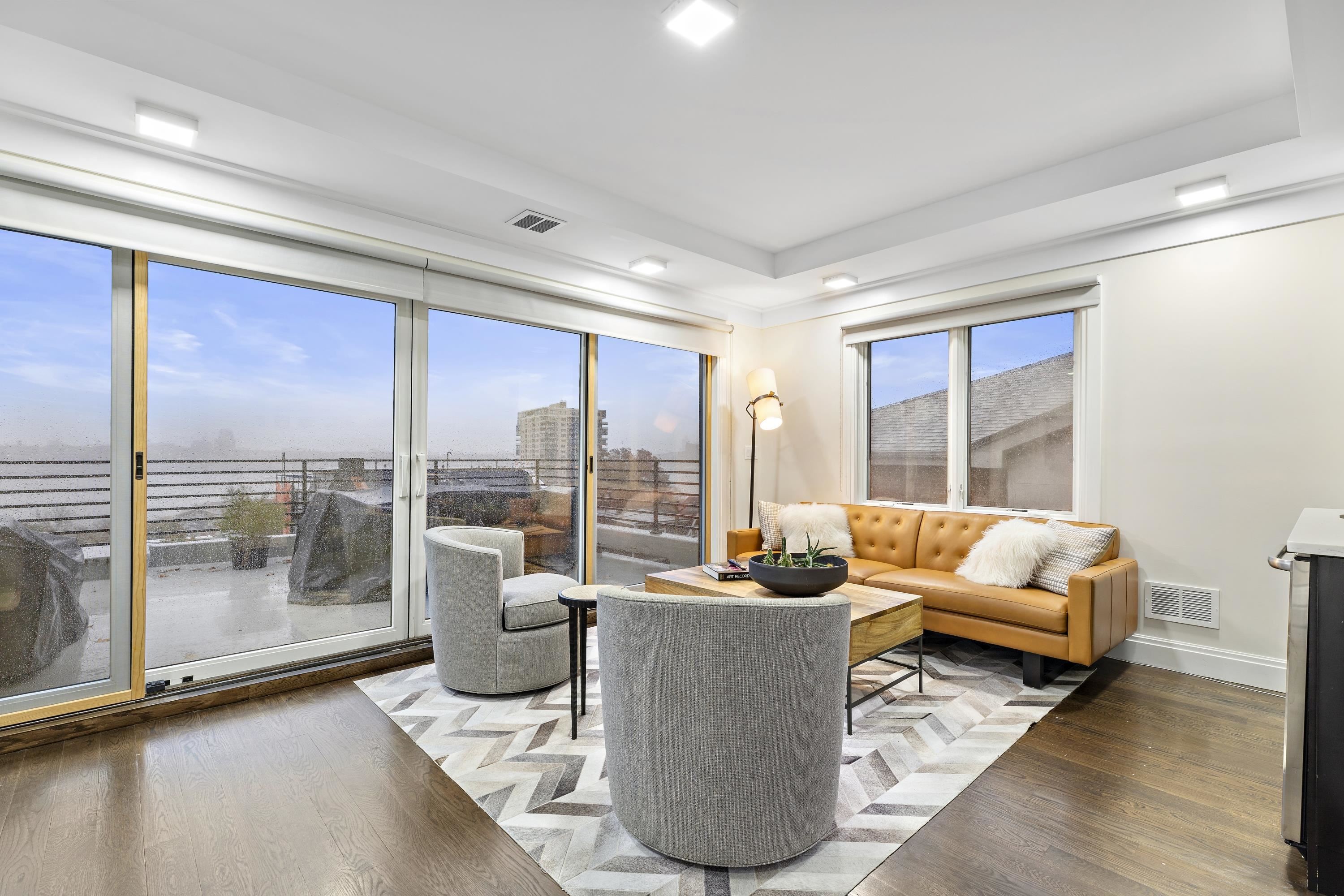 640 Undercliff Avenue Edgewater, NJ 07020 - Photo 22 of 26 a living room with furniture and a floor to ceiling window