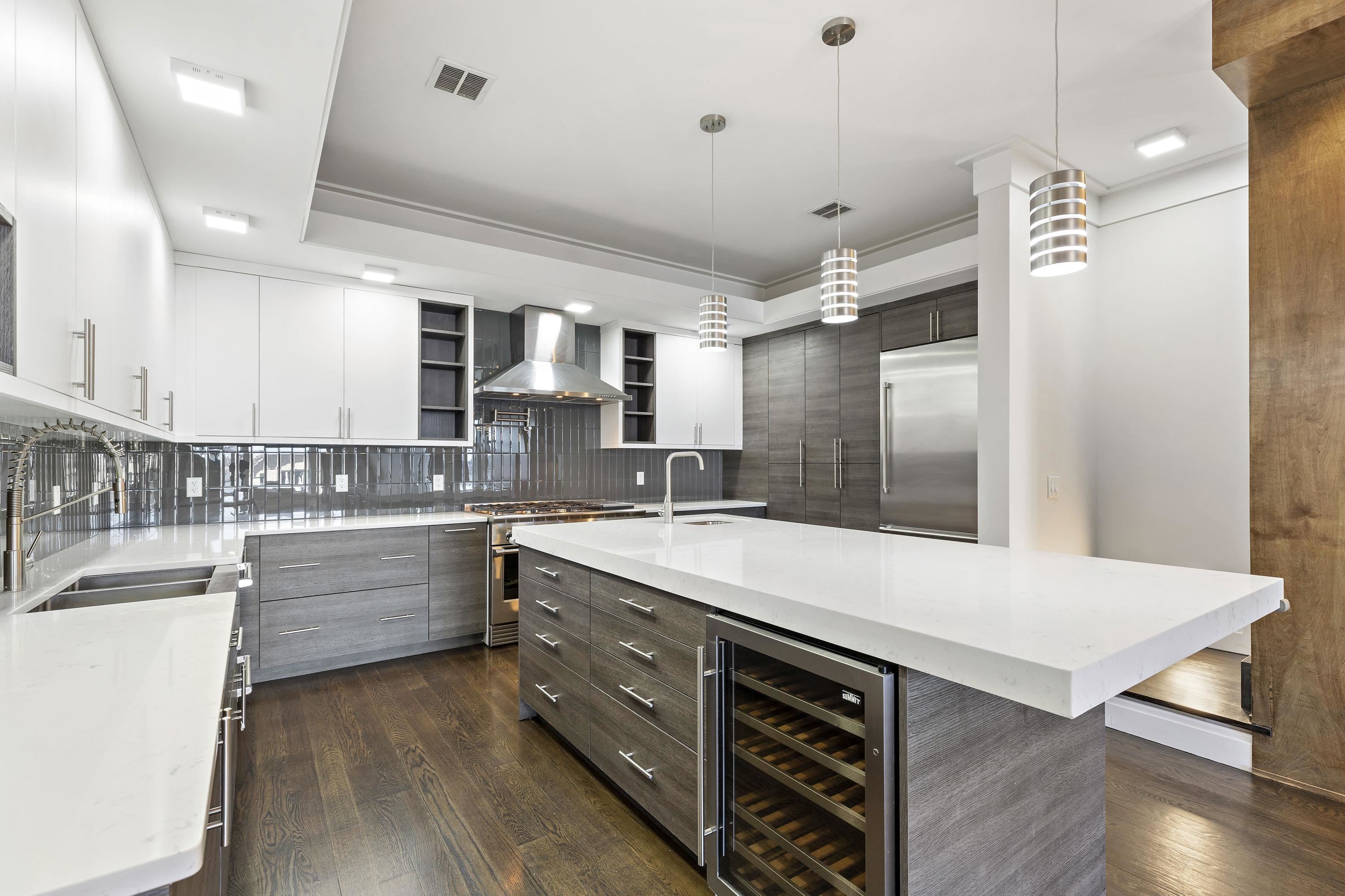 640 Undercliff Avenue Edgewater, NJ 07020 - Photo 6 of 26 a large kitchen with stainless steel appliances kitchen island a large island in the center