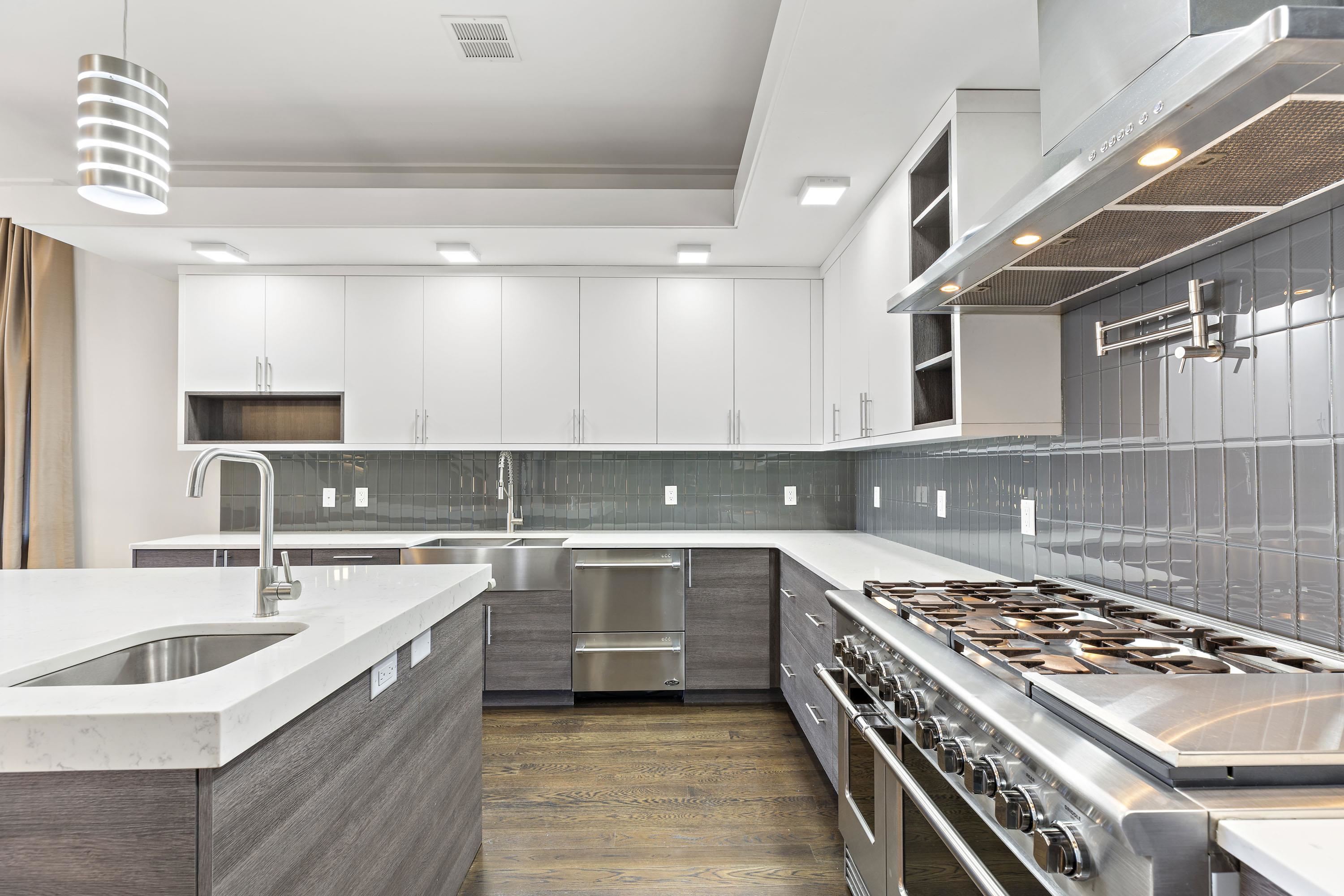 640 Undercliff Avenue Edgewater, NJ 07020 - Photo 8 of 26 a kitchen with a sink stove top oven and cabinets